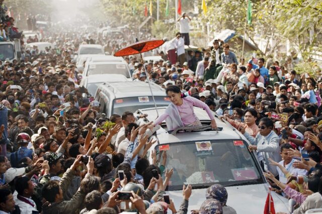 Aung San Suu Kyi -- then Myanmar's opposition leader -- greets supporters during her