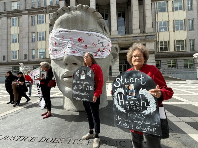 Family members of opiod overdose victims protest outside the US District Court for the Dis