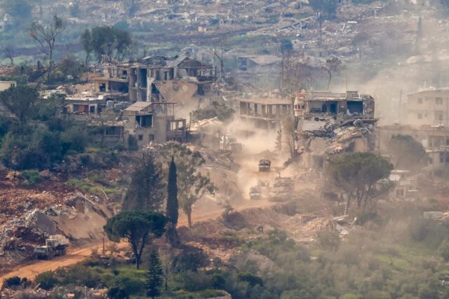 This photograph taken from the northern Israel shows Israeli tanks and military vehicles d