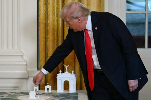 US President Donald Trump, seen on October 15, 2025 displaying early models for a proposed