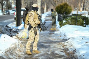 Minnesota charges ICE agent with assault for pointing gun