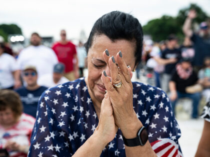 WASHINGTON, DC - MAY 17: An attendee prays during Rededicate 250: A National Jubilee of Pr