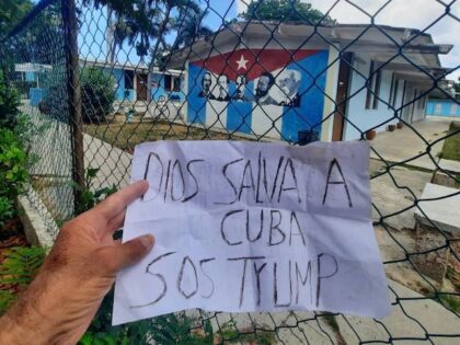 Person holds up sign reading "God save Cuba SOS Trump" in Marianao, Cuba, on May 20, 2026.