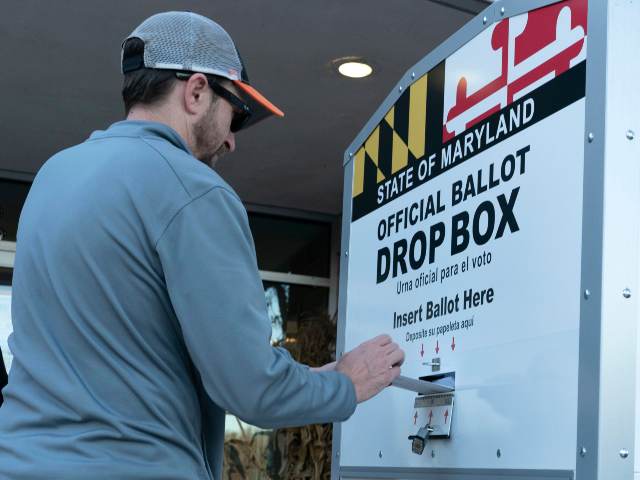 AP22312788898166_ A voter drops his ballot in a drop box at Marilyn J. Praisner Community Recreation Center,