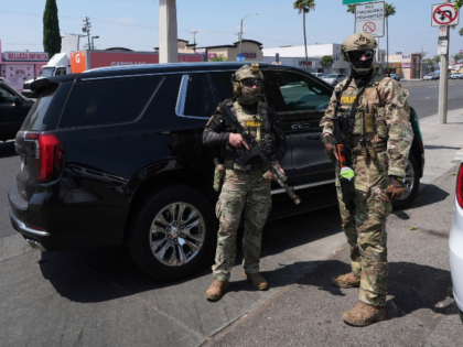 FILE - Immigration agents conduct an operation at a car wash, Aug. 15, 2025, in Montebello
