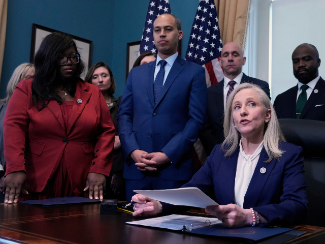 Virginia Gov. Abigail Spanberger, seated right, signs executive orders in the Governors ce