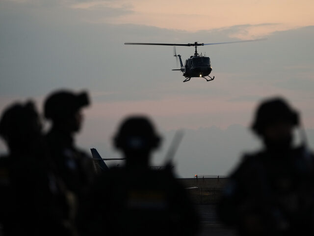 A police helicopter lands at an Air Force base carrying a shipment of drugs seized at a Gu