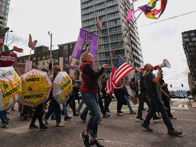 People demonstrate during a "No Kings" protest Saturday, March 28, 2026, in Seat
