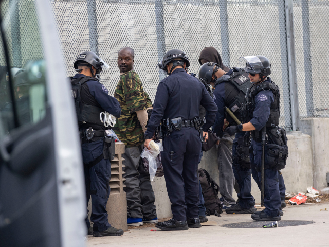 A protester is arrested for failure to disperse outside Metropolitan Detention Center foll