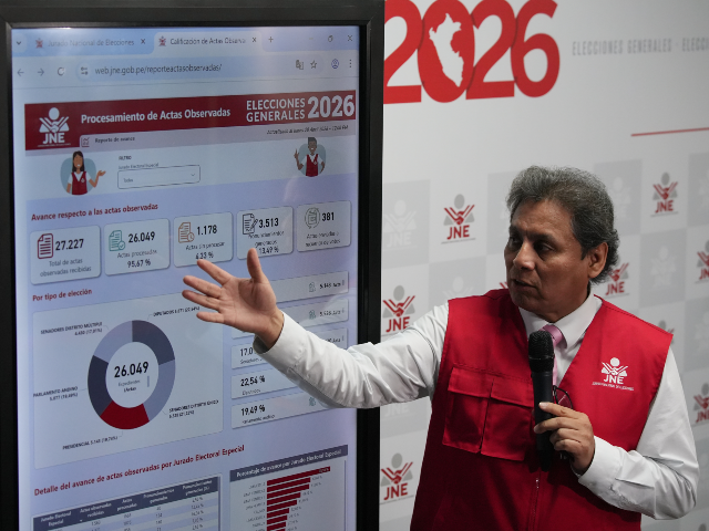 Jorge Valdivia, a spokesman for Peru's National Jury of Elections, shows vote-count r