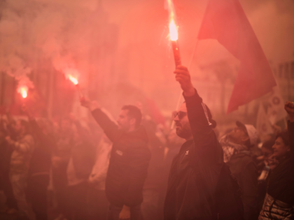 Protester hold flares during in a rally organized by the communist party-affiliated PAME t