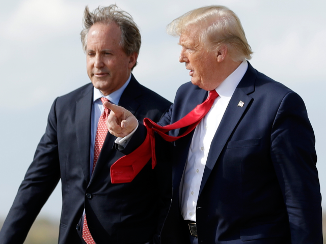 FILE - President Donald Trump walks with Texas Attorney General Ken Paxton, left, at Austi