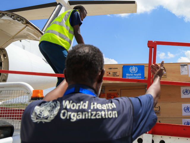 AP26140510410028 Workers load World Health Organization (WHO) emergency supplies onto a United Nations plan