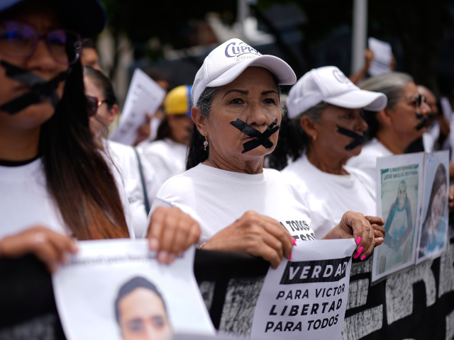 Activists and relatives of prisoners protest in a silent march against deaths of prisoners