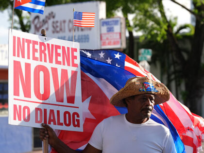 Title: US Cuba Raul Castro Image ID: 26140848517252 Article: Santiago Ferran holds a sign