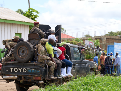 Security forces arrive at the scene of a fire at the Ebola treatment center in Rwampara, C
