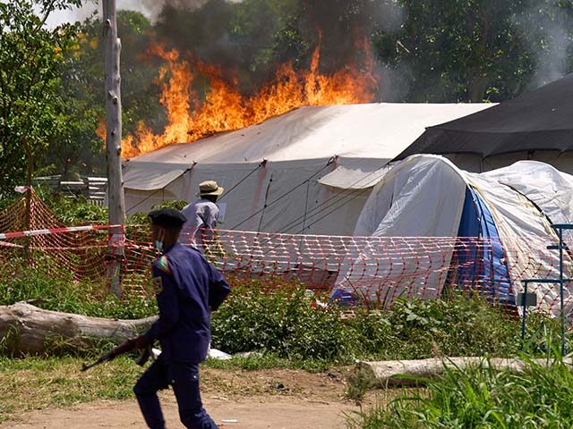 Title: Congo Ebola Image ID: 26141572376873 Article: A security guard runs in front of an