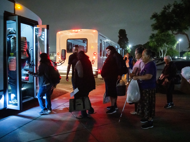 AP26143164352557 Evacuees from an aerospace chemical plant tank leak move to another shelter after the Gard