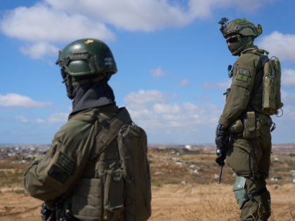 Israeli soldiers occupy a military position overlooking the so-called Yellow Line in the c