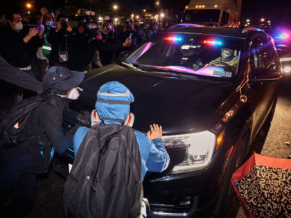 Protesters block ICE cars outside the Delaney Hall detention center during a protest again