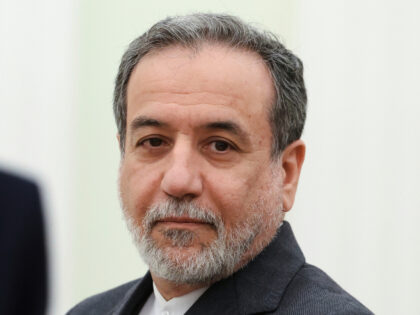 Iranian Foreign Minister Abbas Araghchi stands waiting to meet Russian President Vladimir