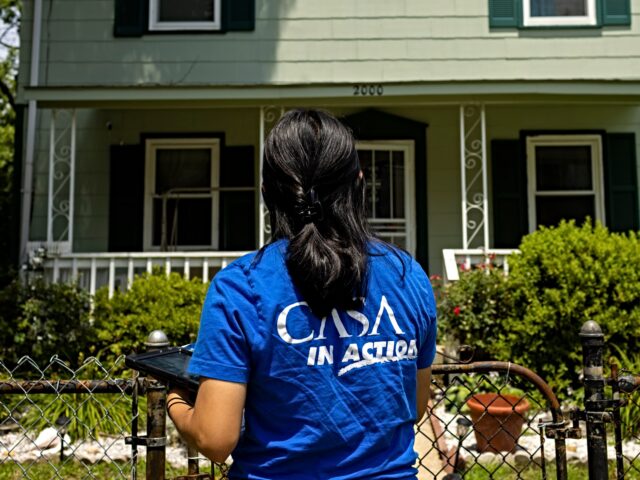 HYATTSVILLE, MD - JULY 13: Cesia Rosales of CASA in Action approaches a home in the Chillu