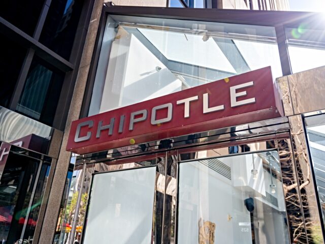 Chipotle Chipotle restaurant storefront with red logo sign on glass and metal facade on a sunny day