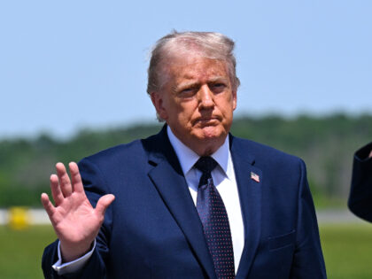 U.S. President Donald Trump waves as he departs Air Force One at Morristown Airport for a