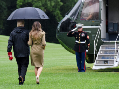 U.S. President Donald Trump walks with first lady Melania Trump prior to their Marine One
