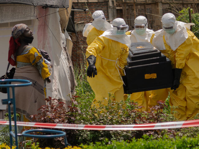 Ebola A woman cries as Red Cross workers carry the coffin of a person who died of Ebola from a h