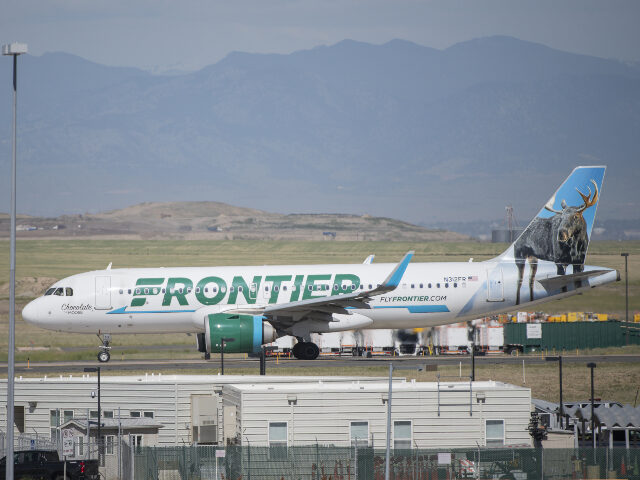 A Frontier Airlines plane taxis on the runway at Denver International Airport in Denver, C