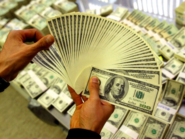 A bank employee counts U.S. dollars at the headquarters of the Korea Exchange Bank Februar