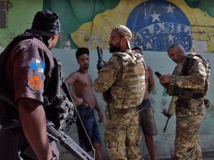 Members of CORE, a Special Operations wing of the Brazilian Civil Police, check the identi