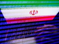 Flag of Iran displayed on a laptop screen and binary code displayed on a screen are seen in this multiple exposure illustration photo taken in Krakow, Poland on September 27, 2022. (Photo by Jakub Porzycki/NurPhoto via Getty Images)