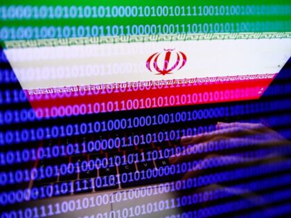 Flag of Iran displayed on a laptop screen and binary code displayed on a screen are seen i