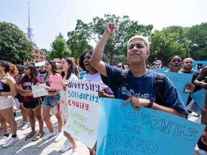 Proponents of affirmative action hold signs during a protest at Harvard University in Camb