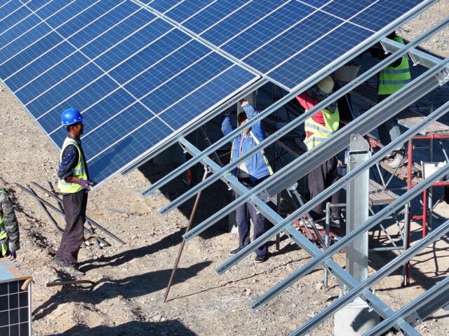 HAMI, CHINA - OCTOBER 26, 2024 - Workers install photovoltaic panels on a 100MW solar ther