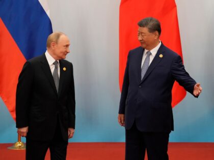 TIANJIN, CHINA - SEPTEMBER 01: Chinese President Xi jinping (R) shows the way to Russian P