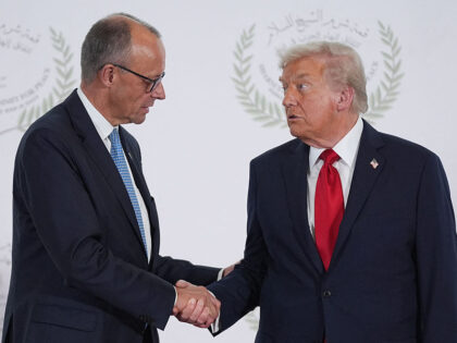 US President Donald Trump greets Germany's Chancellor Friedrich Merz during a summit