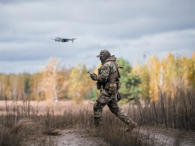 KYIV OBLAST, UKRAINE - OCTOBER 21: A Ukrainian drone pilot controlles a flying drone durin