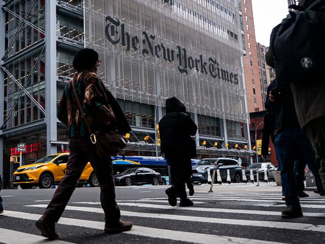 NEW YORK, NEW YORK - JANUARY 14: People walk past The New York Times Building, a 52-story