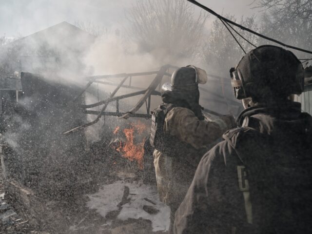 KHERSON, UKRAINE - APRIL 7: State Emergency Service firefighters wearing body armor exting