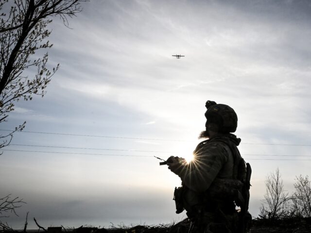 A soldier operates a drone that was blessed by military chaplain Father Stepan before laun