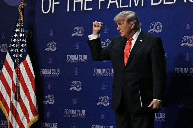 US President Donald Trump makes a fist at The Forum Club of the Palm Beaches Dinner at the