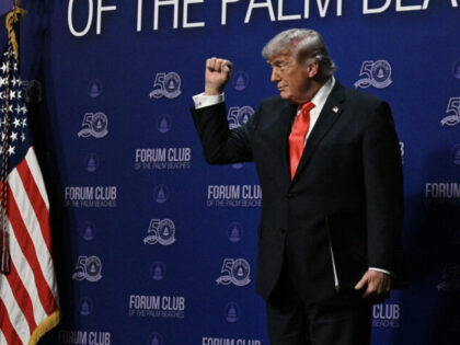 US President Donald Trump makes a fist at The Forum Club of the Palm Beaches Dinner at the