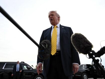 US President Donald Trump speaks with reporters at Palm Beach International Airport in Wes