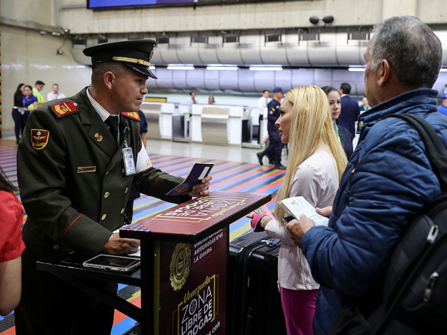 LA GUAIRA, VENEZUELA - APRIL 30: A National Guard officer checks the documents of passenge