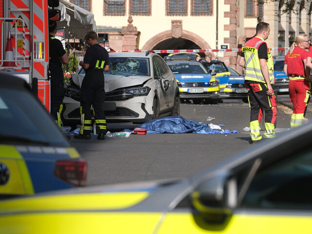 04 May 2026, Saxony, Leipzig: Rescue workers stand next to a damaged car. A car has crashe
