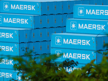SHENZHEN, CHINA - MAY 3: Shipping containers bearing the Maersk logo are stacked at a cont