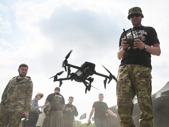 A Ukrainian serviceman pilots a drone during the "Wild Drones" racing competition designed